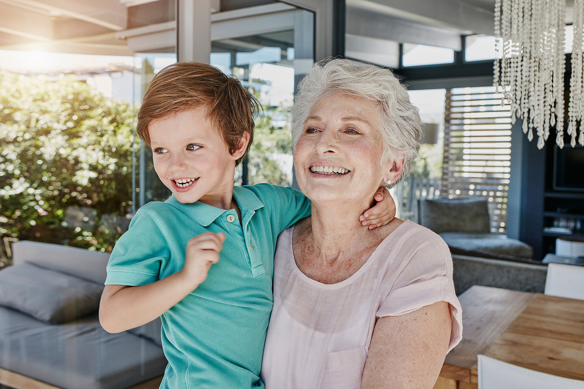A grandmother holds her beaming grandson in her arms