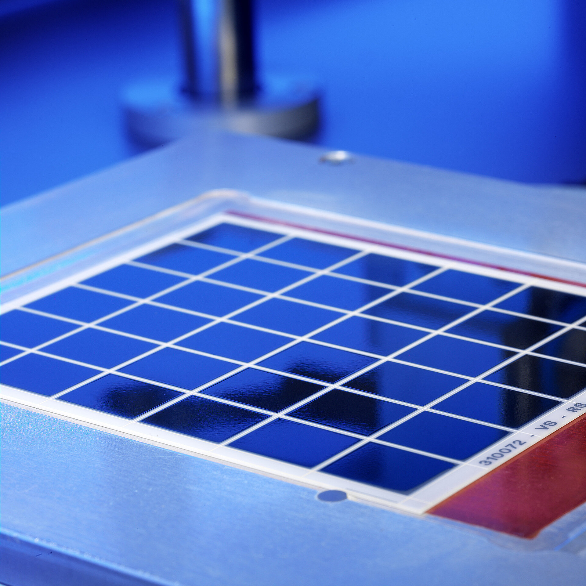 A blue metallised substrate is being machined.