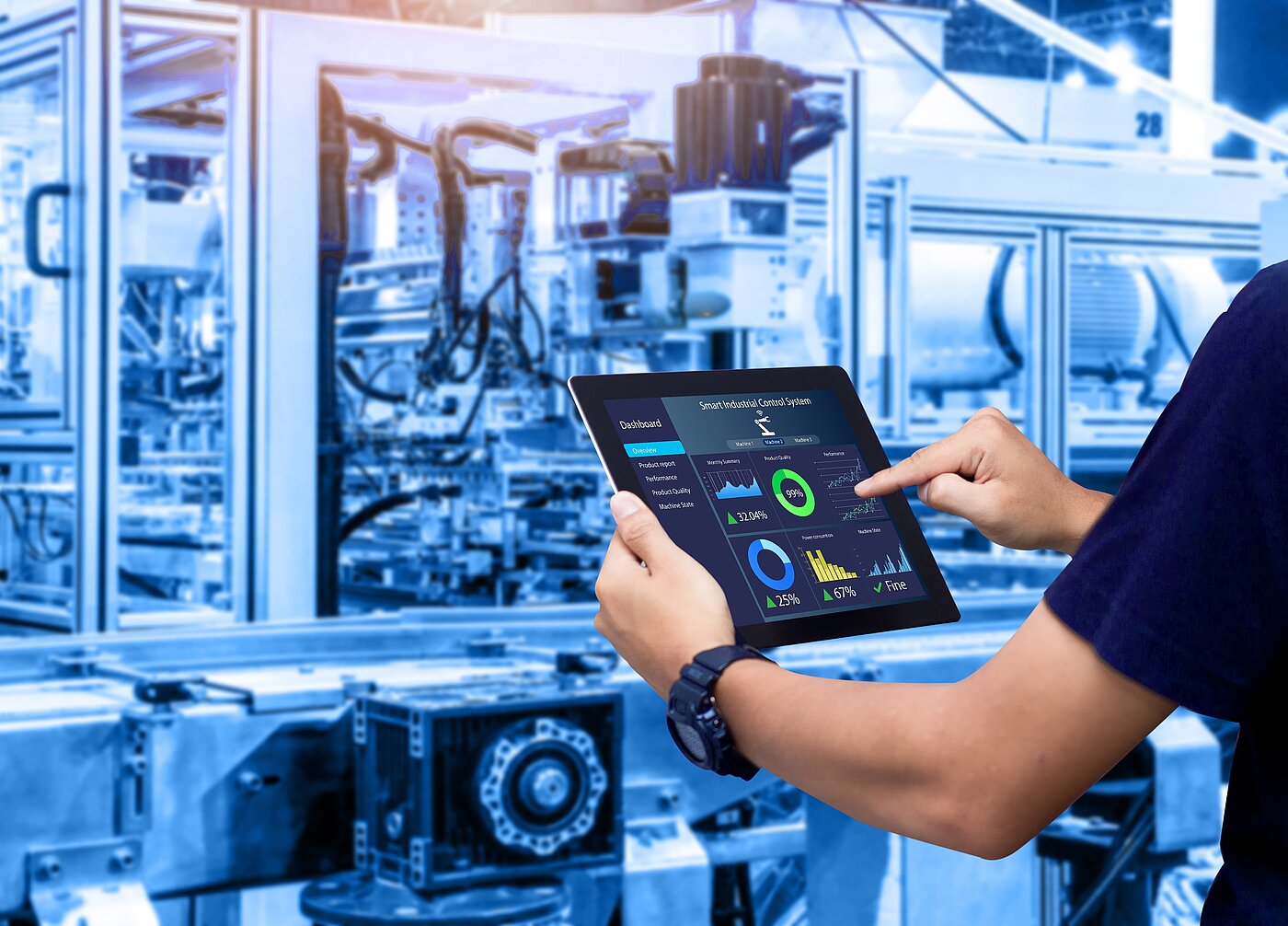 Man in hall with machines works on tablet